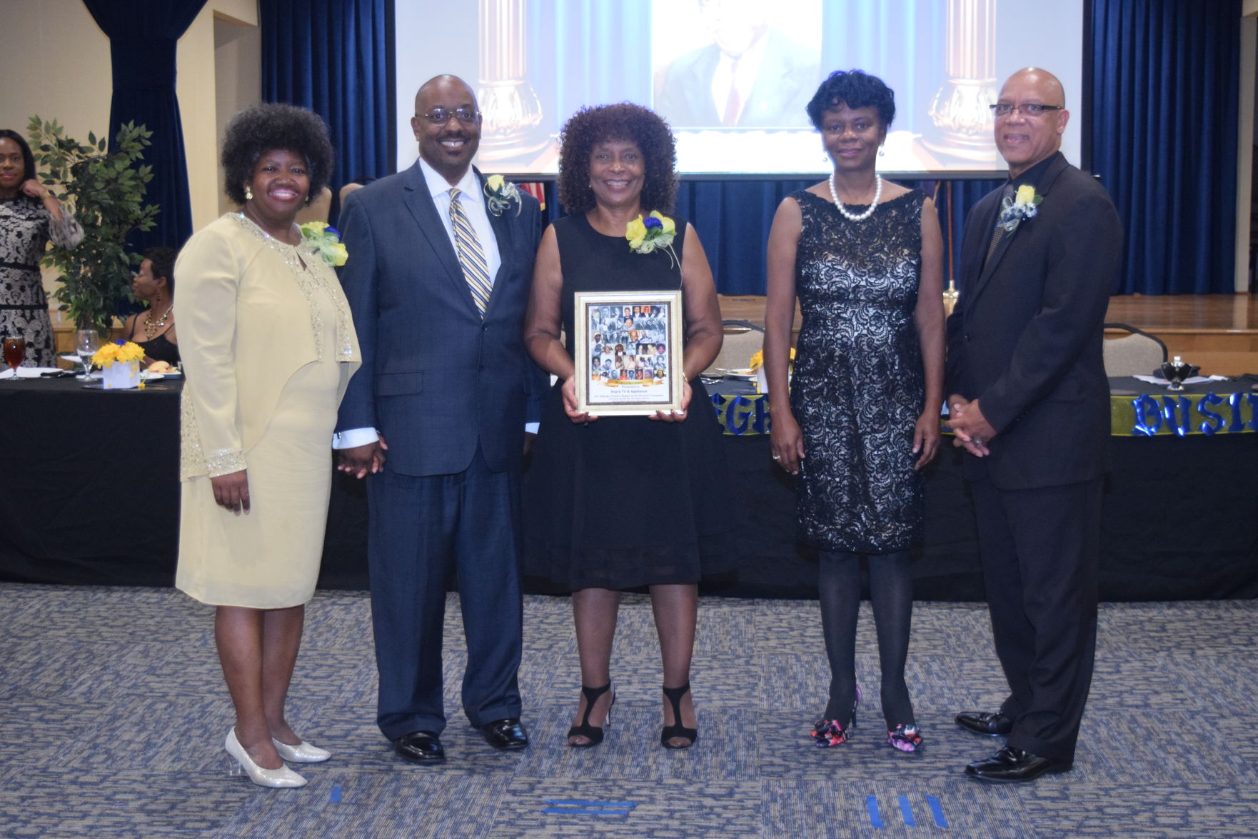 Patricia Hopkins-Solone accepts Legacy Award for Hop's TV & Appliance.